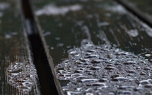 selective focus of water dew on brown wood